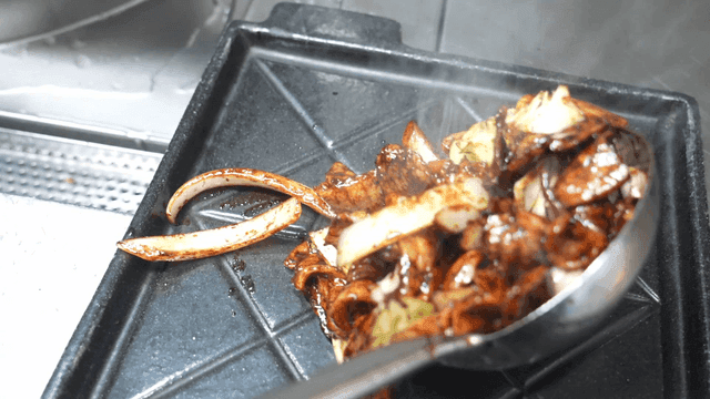 Soy sauce stir-fried pork served on hot plate