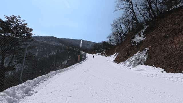 Skiers on snow-covered mountain slope