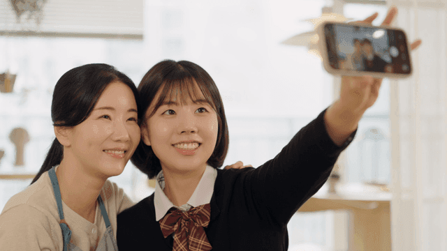 Two women taking a selfie indoors