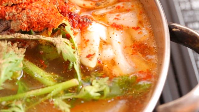 Spicy fish stew with fresh vegetables and trout oil