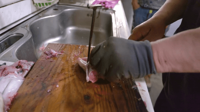 Eel being prepared on a cutting board