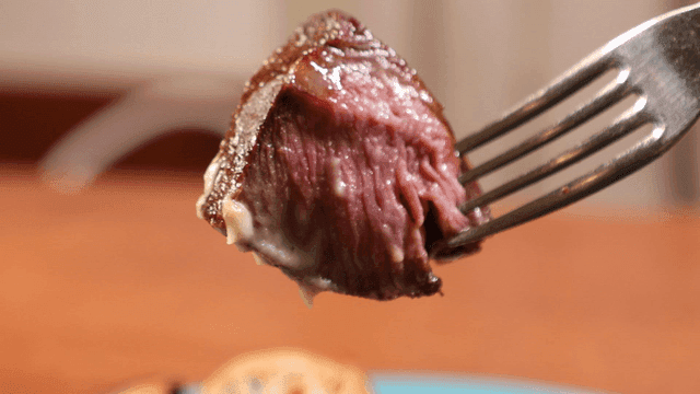 Steak meat pierced with fork