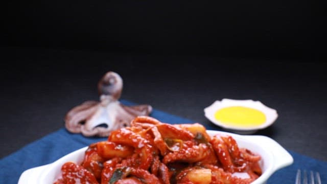Spicy tteokbokki with webfoot octopus in a white dish