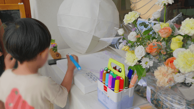 Boy drawing with a marker at a desk