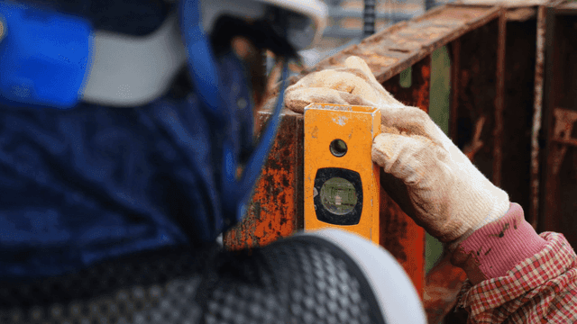 Worker using a level on a construction site