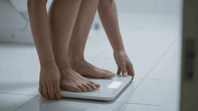 Foot standing on digital scale