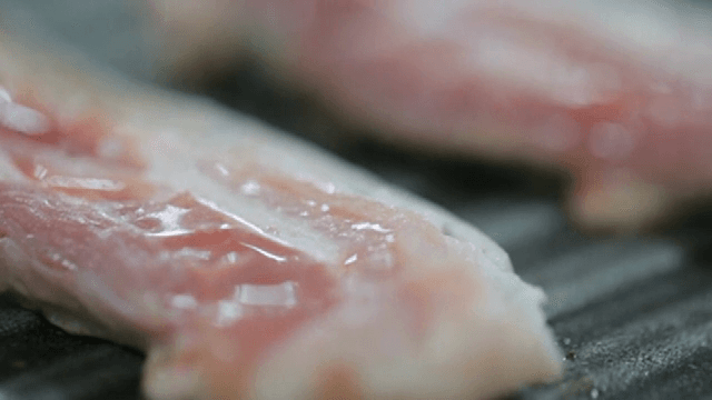 Grilling pork belly on a hot grill