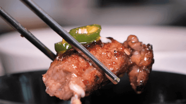 Meat and peppers on chopsticks