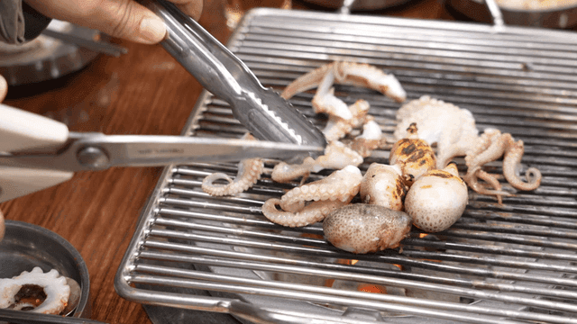 Grilling octopus on a barbecue grill