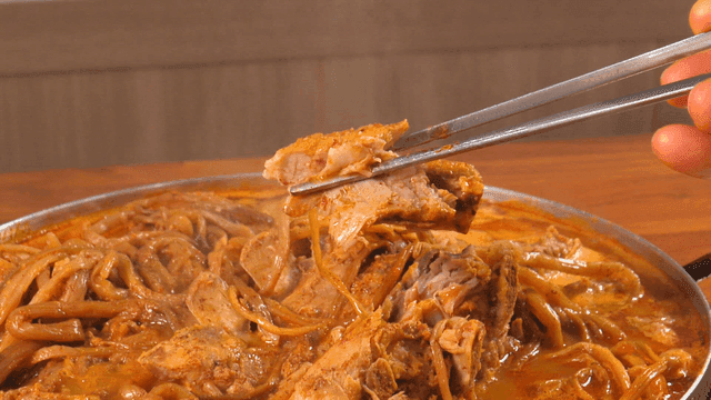 Bite of pork backbone stew with sweet potato stems