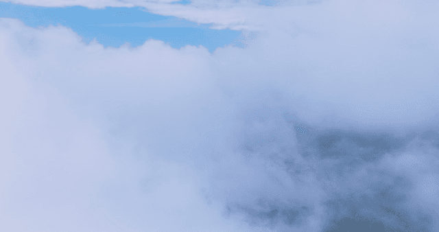 Clouds covering a mountain landscape