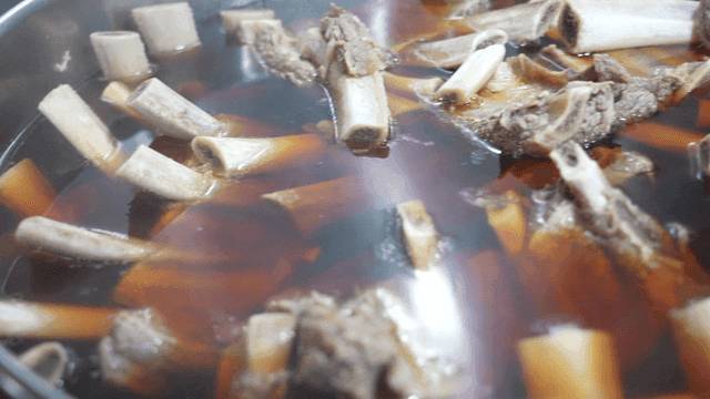 Soy sauce beef short rib soup boiling in pot
