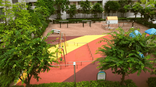 Apartment playground surrounded by trees