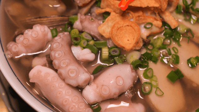 Nourishing seafood rice noodles with clear broth and octopus