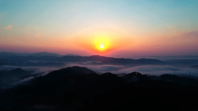 Sunrise over a cloudy mountain landscape