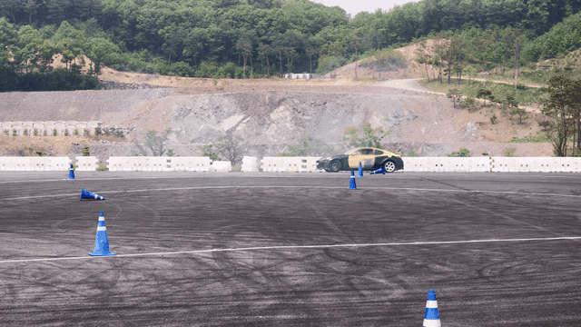 Car maneuvering through cones on a track