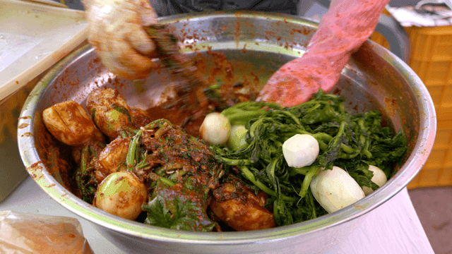 Mixing spicy kimchi seasoning with radish