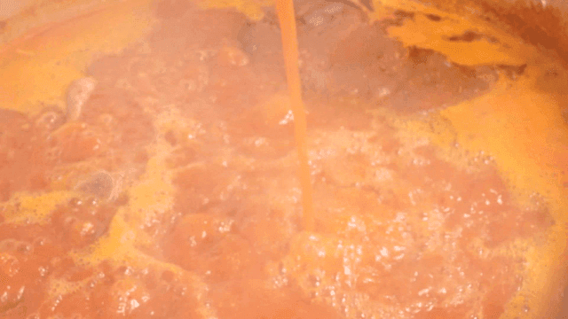 Hot pork backbone stew broth poured from ladle