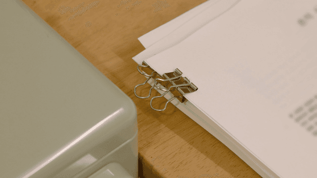 Documents clipped together on a desk