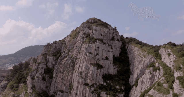A majestic coastal cliff with lush greenery