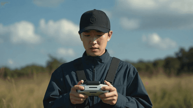 Man operating drone controller in field