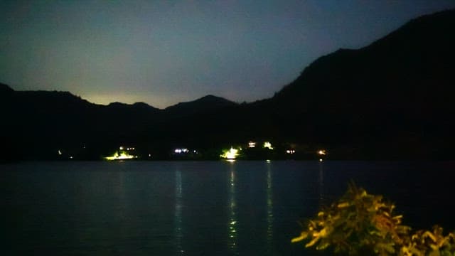 Illuminated viewof a serene lake surrounded by mountains