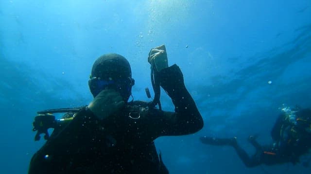 Scuba diver exploring the blue sea with an oxygen tank