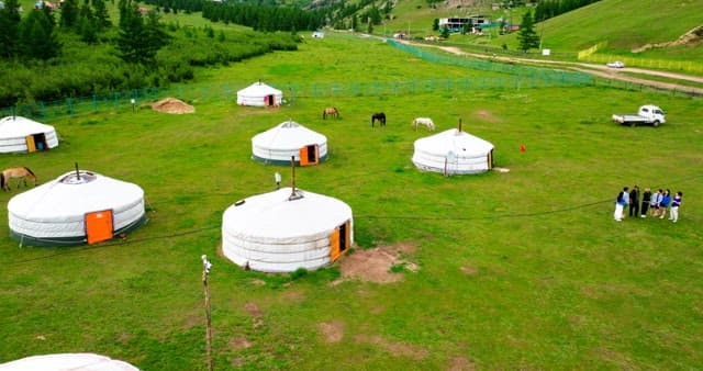 Traditional yurts in a green valley