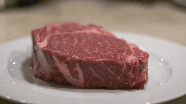 Fresh raw meat steak on plate.