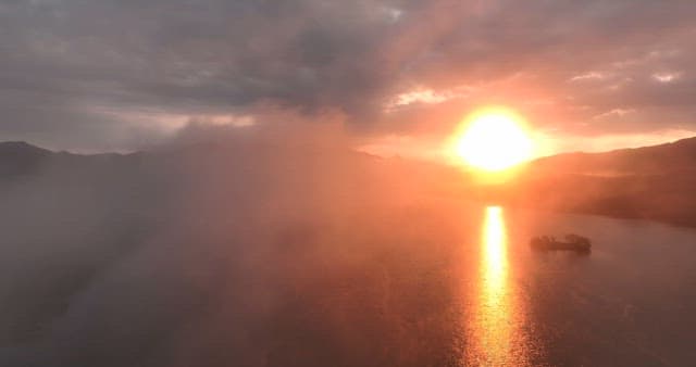 산과 안개가 있는 강의 일몰