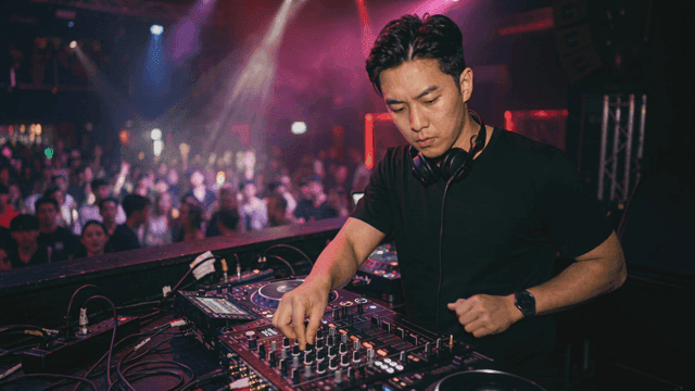 DJ performing in a lively nightclub