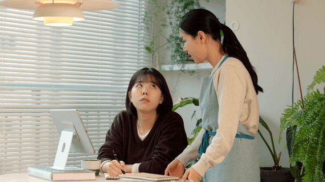 Mother nags her daughter for looking at her phone instead of studying.