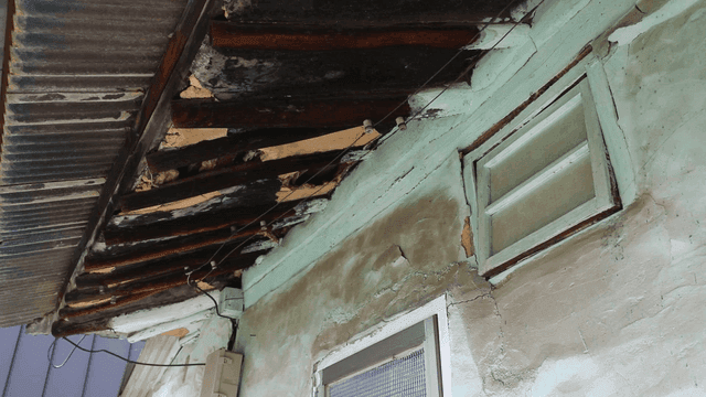 Old house with damaged roof and walls