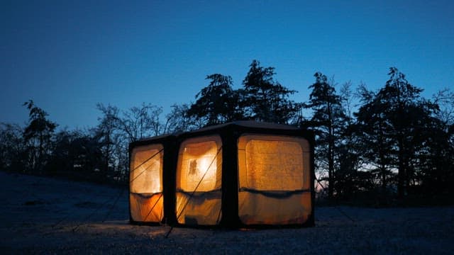 Illuminated Tent in Forest in the Evening 