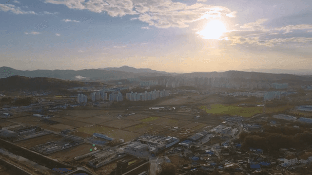 Cityscape with fields and mountains