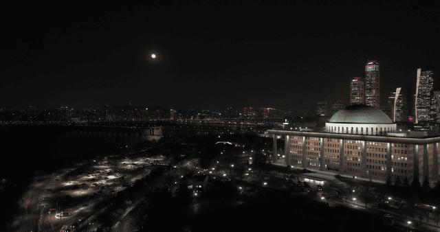 Night view of a city with a full moon