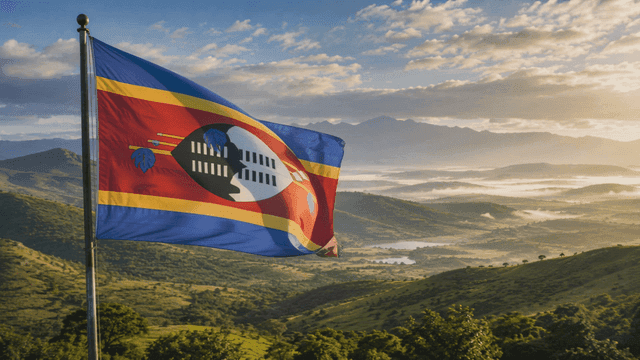 Eswatini flag fluttering over mountainous landscape