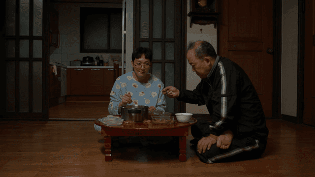 Father and son eating at small table