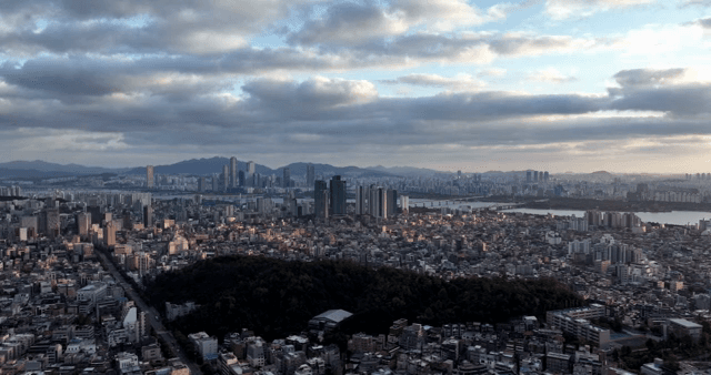 Sprawling cityscape under a cloudy sky