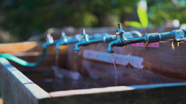 Faucet in an Outdoor Sink Dripping with Water