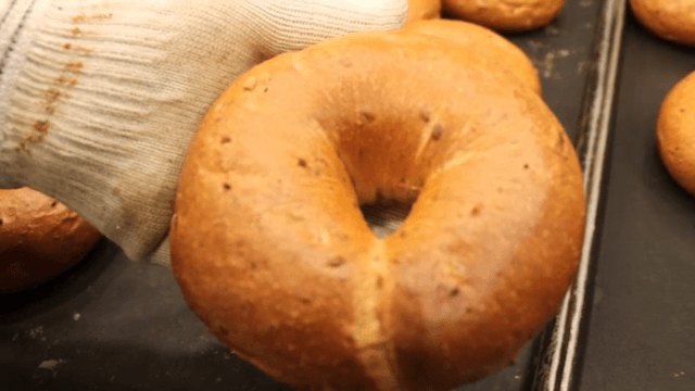 Taking out the freshly baked bagel