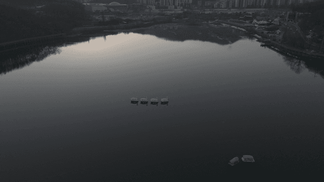 Calm lake and swan boat in evening