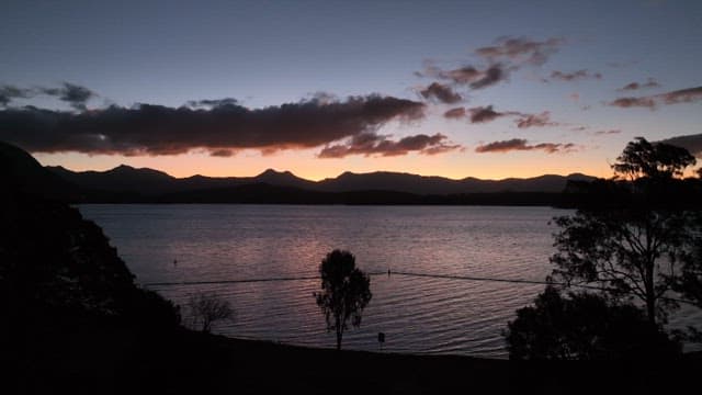 Serene Mogerah lake surrounded by mountains at sunset