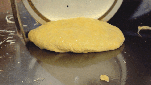 Egg omelet with pot lid on hot griddle