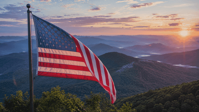 American flag waving over mountain landscape