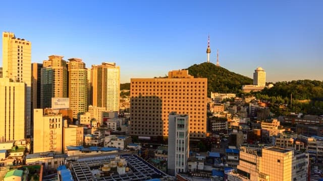 Changing skyline of a bustling city from dusk to night