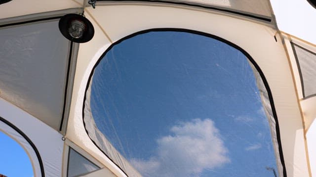 Blue and clear sky reflected in the tent window