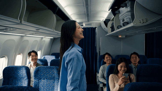 Passengers storing luggage in airplane cabin