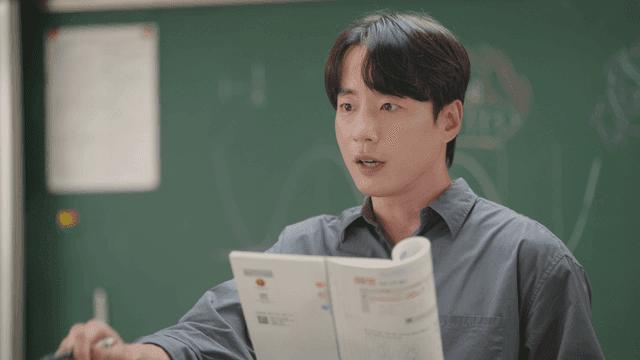 Teacher explaining a textbook in class