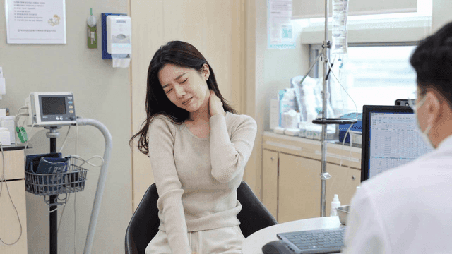 Women suffering from neck pain at clinic